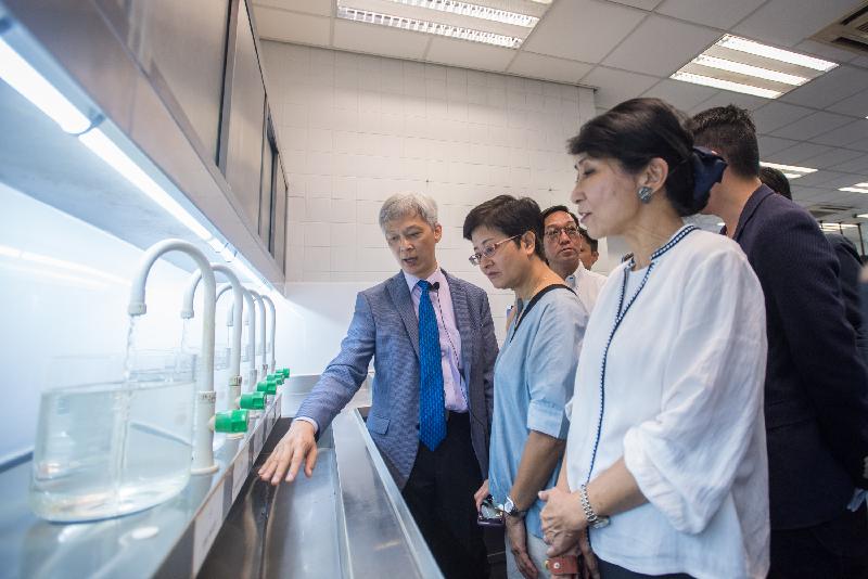 Members of the Legislative Council observe the quality of water which has undergone various stages of treatment procedures during their visit to Tai Po Water Treatment Works today (May 22).