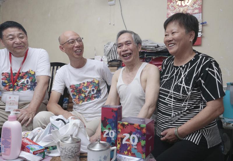 The Secretary for the Environment, Mr Wong Kam-sing (second left), together with volunteers, visits the elderly and families in need at Choi Yuen Estate in Sheung Shui to understand their living conditions and needs and distributes gift packs.