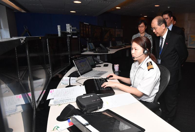 Accompanied by the Director of Marine, Ms Maisie Cheng (back row, first left), the Chief Secretary for Administration, Mr Matthew Cheung Kin-chung (first right), today (June 12) visits the Vessel Traffic Centre located at the Hong Kong-Macau Ferry Terminal and learned about the Vessel Traffic system.
