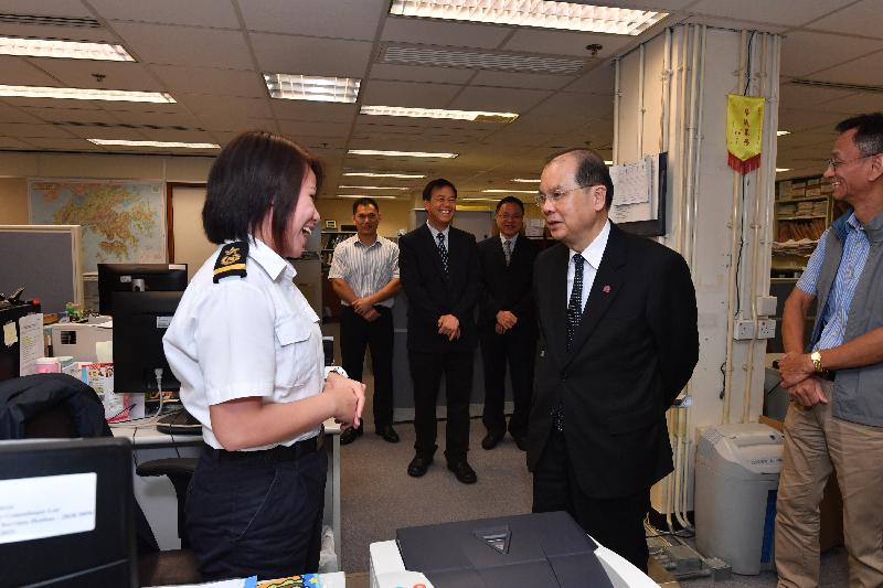 The Chief Secretary for Administration, Mr Matthew Cheung Kin-chung (second right), today (June 12) tours the Central Marine Office of the Marine Department and chats with the staff to better understand the daily work of the office, including processing licence applications and renewals for local vessels, and handling reports on departures and arrivals of local vessels and ocean-going vessels.