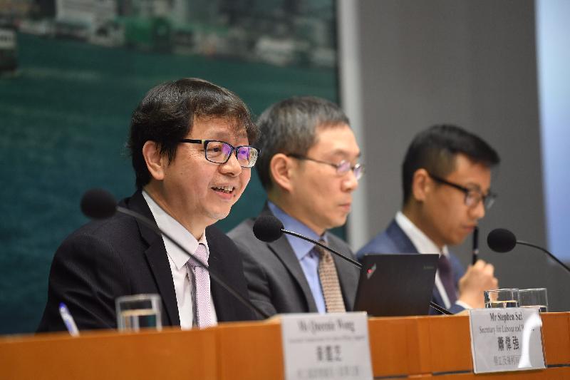 The Secretary for Labour and Welfare, Mr Stephen Sui (left), attended a press conference on the general framework on working hours policy today (June 13) to briefly introduce the relevant recommendations and measures. Picture shows Mr Sui answering a question raised by a reporter.