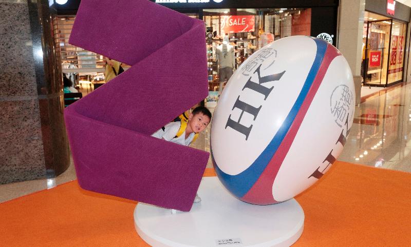 The "HKSAR 20th Anniversary Roving Exhibition" opens at Plaza Hollywood in Diamond Hill today (June 16). Photo shows a boy posing for photos next to the rugby ball installation. 