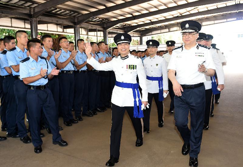 Deputy Commissioner of Police (Management), Mr Chau Kwok-leung, accompanied by the Commissioner of Police, Mr Lo Wai-chung, meets the graduates after the passing-out parade.