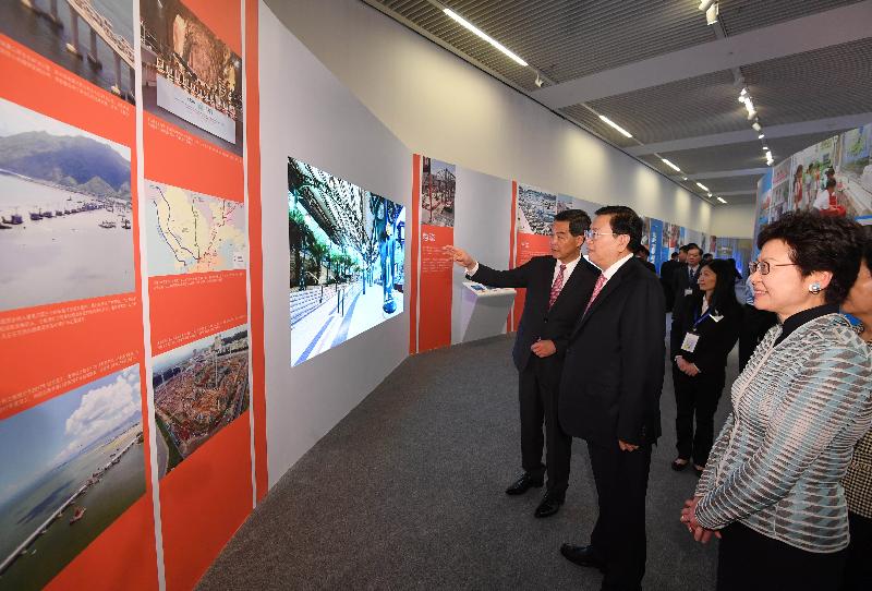 Member of the Standing Committee of the Political Bureau of the CPC Central Committee and Chairman of the Standing Committee of the National People's Congress Mr Zhang Dejiang (centre), accompanied by the Chief Executive, Mr C Y Leung (left), and the Chief Executive-elect, Mrs Carrie Lam (right), tours "Together · Progress · Opportunity - Exhibition in Celebration of the 20th Anniversary of the Return of Hong Kong to the Motherland" in Beijing today (June 26). Picture shows Mr Leung introducing to Mr Zhang the development of infrastructure of Hong Kong.