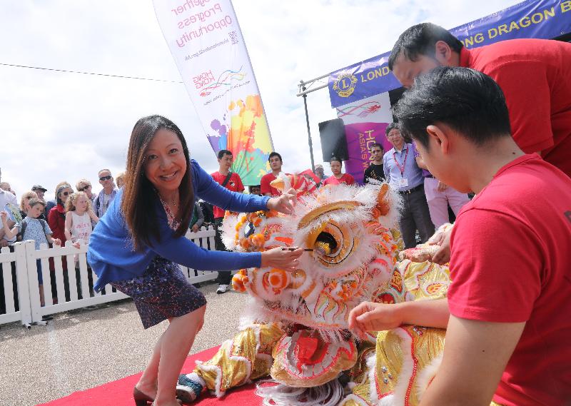The London Hong Kong Dragon Boat Festival 2017 was held on June 25 (London time) in London's Docklands. Picture shows the Director-General of the Hong Kong Economic and Trade Office, London, Ms Priscilla To (left), dotting the eyes of a Chinese lion at the official starting ceremony of the festival.