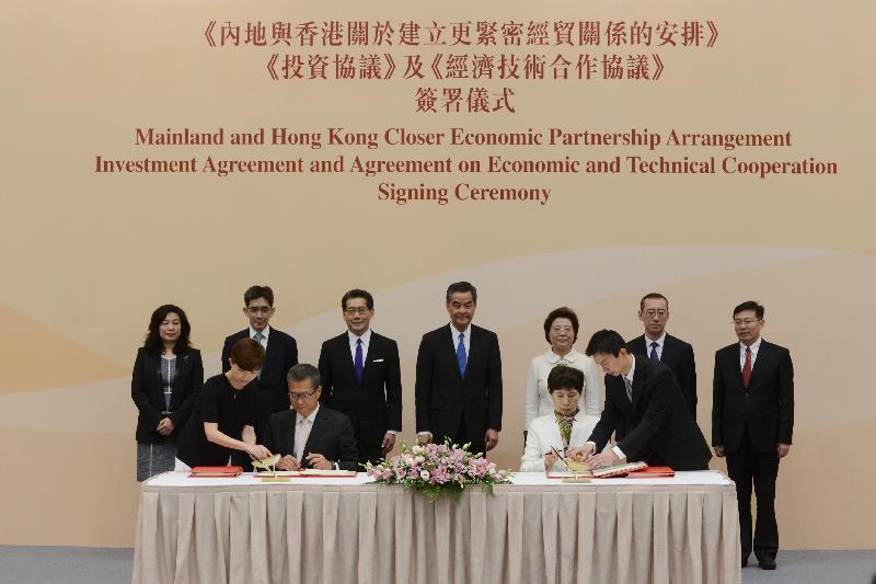 The Chief Executive, Mr C Y Leung, attended the Mainland and Hong Kong Closer Economic Partnership Arrangement Investment Agreement and Agreement on Economic and Technical Cooperation Signing Ceremony today (June 28). Photo shows (back row, from left) the Director-General of Trade and Industry, Ms Salina Yan; the Permanent Secretary for Commerce and Economic Development (Commerce, Industry and Tourism), Mr Philip Yung; the Secretary for Commerce and Economic Development, Mr Gregory So; Mr Leung; Deputy Director of the Liaison Office of the Central People's Government in the Hong Kong Special Administrative Region Ms Qiu Hong; the Director-General of the Department of Taiwan, Hong Kong and Macao Affairs of the Ministry of Commerce, Mr Sun Tong; and the Director-General of the Department of Exchange and Cooperation of the Hong Kong and Macao Affairs Office of the State Council, Mr Qian Yibing, witnessing the signing of the agreements by the Financial Secretary, Mr Paul Chan (front row, second left), and Vice-Minister of Commerce Ms Gao Yan (front row, second right). 
