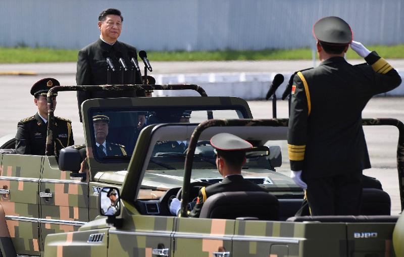 President Xi Jinping receives a salute from the Commander-in-chief of the People's Liberation Army Hong Kong Garrison, Lieutenant General Tan Benhong, before inspecting troops by car at Shek Kong Barracks this morning (June 30).