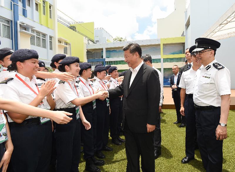 President Xi Jinping (centre) today (June 30) is greeted by Junior Police Call (JPC) members upon his arrival at the JPC Permanent Activity Centre and Integrated Youth Training Camp. Looking on is the Commissioner of Police, Mr Lo Wai-chung (first right).