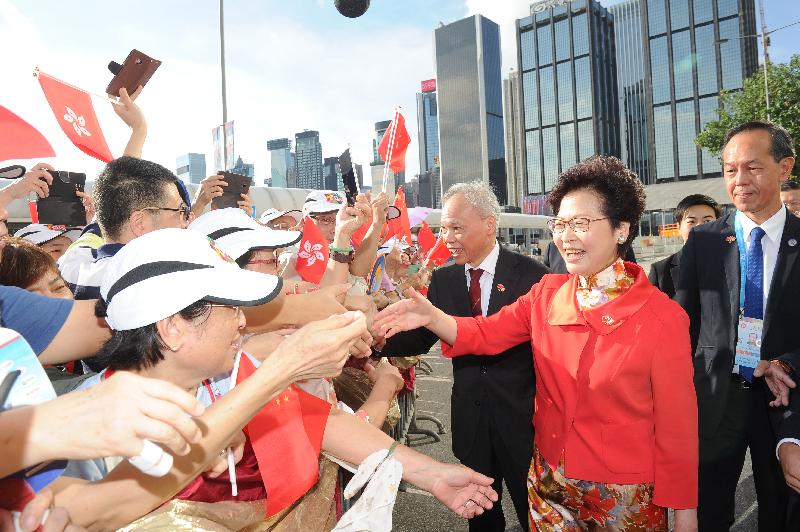 The Chief Executive, Mrs Carrie Lam (second right), greets members of the public before the Flag Raising Ceremony to Celebrate the 20th Anniversary of the Establishment of the Hong Kong Special Administrative Region of the People's Republic of China at Golden Bauhinia Square this morning (July 1). Joining her is her husband Mr Lam Siu-por (third right).