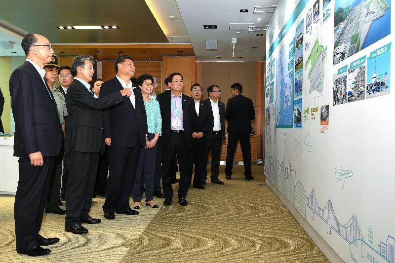 President Xi Jinping (third left) today (July 1) views display panels at the HKIA Tower and listens to an introduction by the Chairman of the Airport Authority Hong Kong (AA), Mr Jack So (second left), on the role of the Hong Kong International Airport in supporting the development of the Guangdong-Hong Kong-Macao Bay Area. Also present are the Chief Executive, Mrs Carrie Lam (fourth left); the Secretary for Transport and Housing, Mr Frank Chan Fan (first left); and the Chief Executive Officer of the AA, Mr Fred Lam (fifth left).