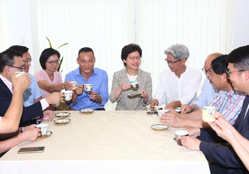 The Chief Executive, Mrs Carrie Lam (fifth right), meets villagers of the Chuk Yuen Village to understand their livelihood in their new homes today (July 2).