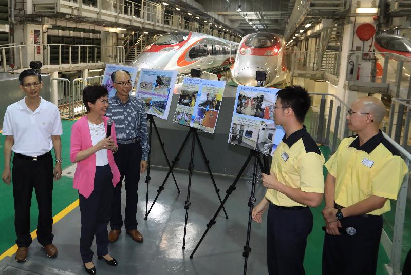 The Chief Executive, Mrs Carrie Lam, visited the Shek Kong Stabling Sidings of the Hong Kong section of the Guangzhou-Shenzhen-Hong Kong Express Rail Link (XRL) this morning (July 9) and viewed the XRL train which has been delivered to Hong Kong. Photo shows Mrs Lam (second left); the Secretary for Transport and Housing, Mr Frank Chan Fan (third left); and the Director of Highways, Mr Daniel Chung (first left), chatting with XRL train drivers (first and second right).