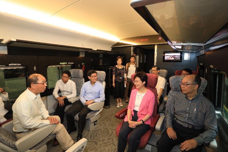 The Chief Executive, Mrs Carrie Lam, visited the Shek Kong Stabling Sidings of the Hong Kong section of the Guangzhou-Shenzhen-Hong Kong Express Rail Link (XRL) this morning (July 9) and viewed the XRL train which has been delivered to Hong Kong. Photo shows Mrs Lam (front row, second right); and the Secretary for Transport and Housing, Mr Frank Chan Fan (front row, first right), viewing an XRL train compartment.