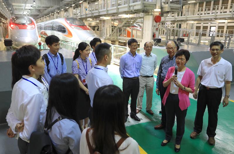The Chief Executive, Mrs Carrie Lam, visited the Shek Kong Stabling Sidings of the Hong Kong section of the Guangzhou-Shenzhen-Hong Kong Express Rail Link (XRL) this morning (July 9) and viewed the XRL train which has been delivered to Hong Kong. Photo shows Mrs Lam (second right); the Secretary for Transport and Housing, Mr Frank Chan Fan (third right); and the Director of Highways, Mr Daniel Chung (first right), chatting with young engineers from the Electrical and Mechnical Services Department and the MTRCL to learn about their daily work.