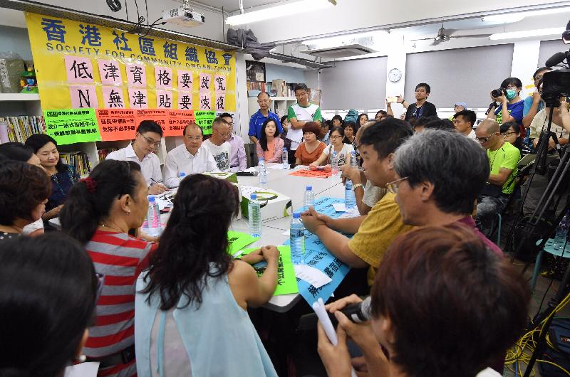 The Chief Secretary for Administration, Mr Matthew Cheung Kin-chung, met with members of the Society for Community Organization and resident representatives in Sham Shui Po this afternoon (July 14) to discuss social welfare policies. Photo shows Mr Cheung listening to the views of local residents in the meeting.
