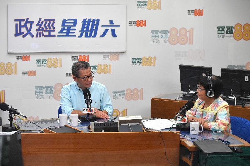 The Financial Secretary, Mr Paul Chan (left), attends Commercial Radio's programme "Saturday Forum" this morning (July 22). 
