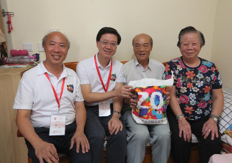 The Secretary for Security, Mr John Lee (second left), accompanied by the Chairman of the Sha Tin District Council, Mr Ho Hau-cheung (first left), today (July 26) visits an elderly family in Yan On Estate in Ma On Shan to learn more about their daily life.