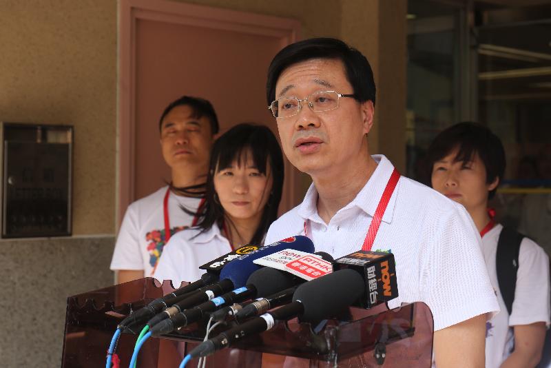 The Secretary for Security, Mr John Lee, speaks to the media before the home visits under the "Celebrations for All" project in Sha Tin today (July 26).