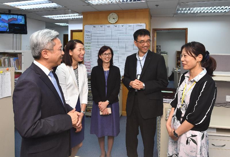 In touring the Family and Child Protective Services Unit (Eastern and Wan Chai) today (August 2), the Secretary for the Civil Service, Mr Joshua Law (first left), is briefed by colleagues on the assistance they provide to families with problems of child abuse or spousal battery.