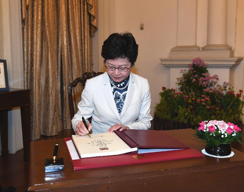 The Chief Executive, Mrs Carrie Lam, continued her visit to Singapore today (August 3). Photo shows Mrs Lam signing the guest book before meeting the Prime Minister of Singapore, Mr Lee Hsien Loong.