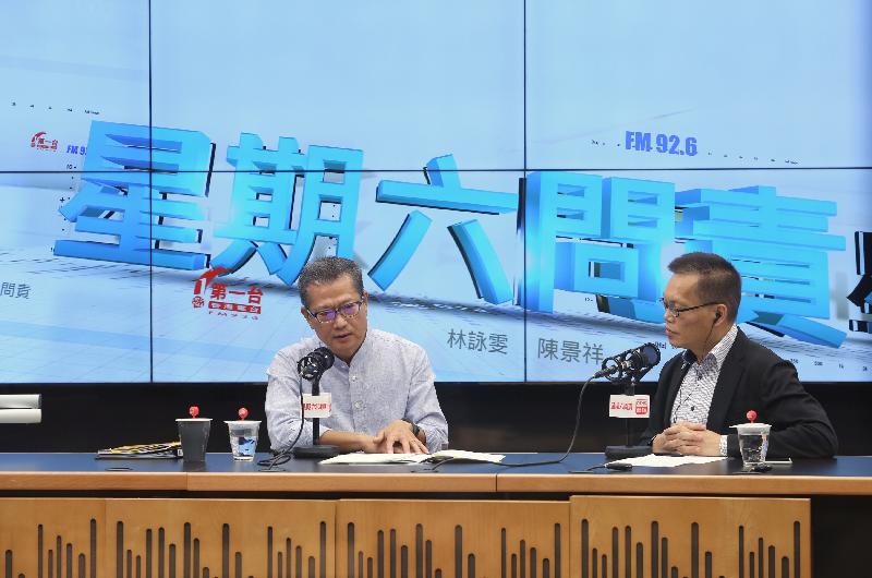 The Financial Secretary, Mr Paul Chan (left), attends Radio Television Hong Kong's "Accountability" this morning (August 5).