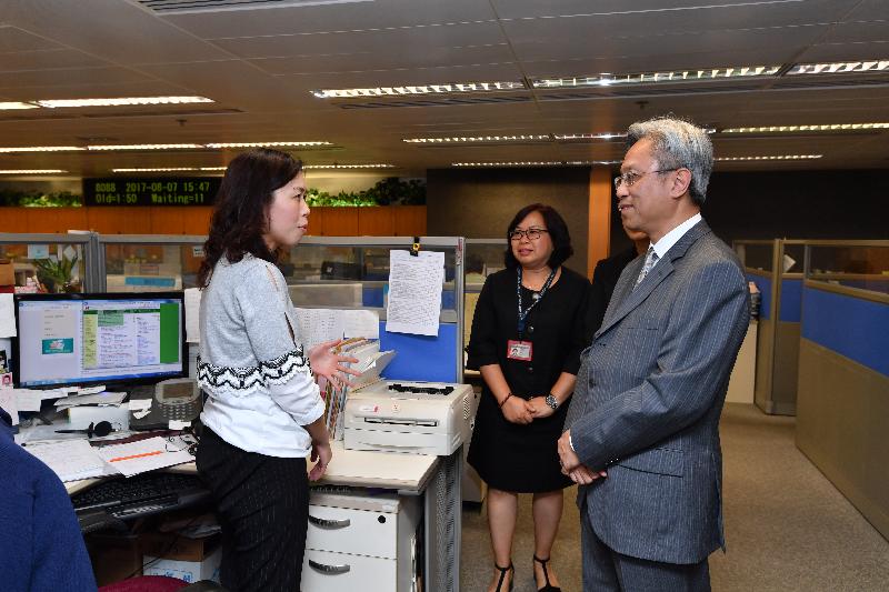 The Secretary for the Civil Service, Mr Joshua Law (right), today (August 7) visits the Central Telephone Enquiry centre of the Inland Revenue Department and is briefed by front-line staff on their services to the public.