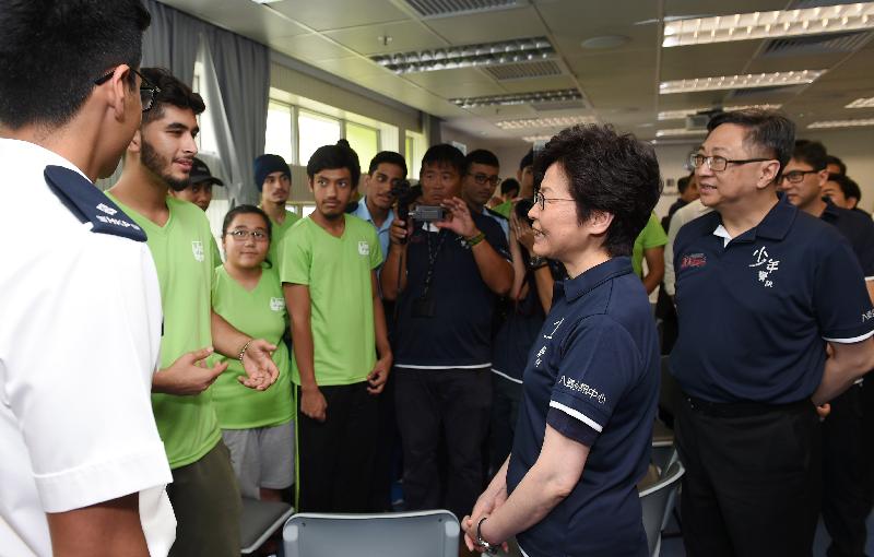 The Chief Executive, Mrs Carrie Lam (centre), chats with non-ethnic Chinese members of Junior Police Call in the Junior Police Call Permanent Activity Centre and Integrated Youth Training Camp. Looking on is the Commissioner of Police, Mr Lo Wai-chung (first right).