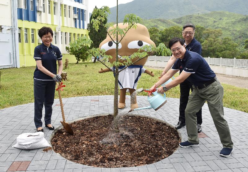 The officiating guests and Big Waster join a tree planting activity to commemorate the official opening of the Junior Police Call Permanent Activity Centre and Integrated Youth Training Camp.

