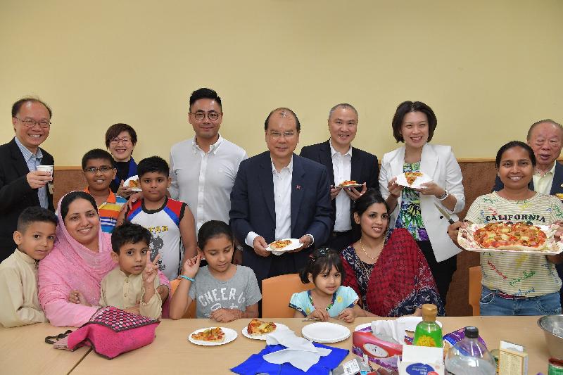 The Chief Secretary for Administration, Mr Matthew Cheung Kin-chung (back row, centre), observes how ethnic minorities attend a cooking class in the Mong Kok Kai Fong Association Limited (MKKFA) Chan Hing Social Service Centre during his visit to Yau Tsim Mong District this afternoon (August 10). Also present were the Chief Executive Officer of the MKKFA Chan Hing Social Service Centre, Mr Suen Leung-kwong (back row, first left); the District Officer (Yau Tsim Mong), Mrs Laura Aron (back row, second left); the Chairman of the Yau Tsim Mong District Council (YTMDC), Mr Chris Ip (back row, third left); the Chairman of the Management Committee of the MKKFA, Mr Leung Wah-shing (back row, third right); the Vice Chairman of the YTMDC, Ms Wong Shu-ming (back row, second right); and the Vice Chairman of the Management Committee of the MKKFA, Mr Kwok Wing-cheong (back row, first right).