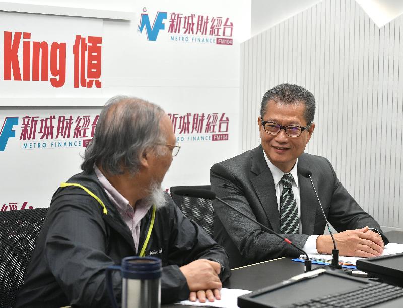 The Financial Secretary, Mr Paul Chan (right), attends Metro Radio's programme "Breakfast with Heung Shu Fai" this morning (August 14).