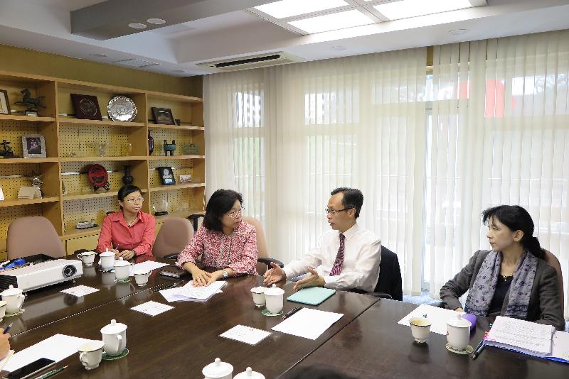 The Secretary for Constitutional and Mainland Affairs, Mr Patrick Nip (second right), visits the Office of the Government of the Hong Kong Special Administrative Region in Beijing today (August 15) and is briefed by the Director of the Beijing Office, Ms Gracie Foo (second left), on the work of the office.