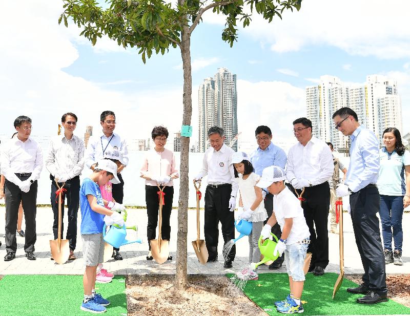 The Chief Executive, Mrs Carrie Lam, attended the ceremony for the Kai San Road Opening and Community Planting Day at the Kai Tak Development Area today (August 16). Picture shows Mrs Lam (back row, fourth left); the Secretary for Development, Mr Michael Wong (back row, third left); the Permanent Secretary for Development (Works), Mr Hon Chi-keung (back row, fifth left); the Director of Civil Engineering and Development, Mr Lam Sai-hung (back row, sixth left); the Chairman of the Wong Tai Sin District Council, Mr Li Tak-hong (back row, seventh left); the Chairman of the Kowloon City District Council, Mr Pun Kwok-wah (back row, second left); and other guests officiating at the planting ceremony.