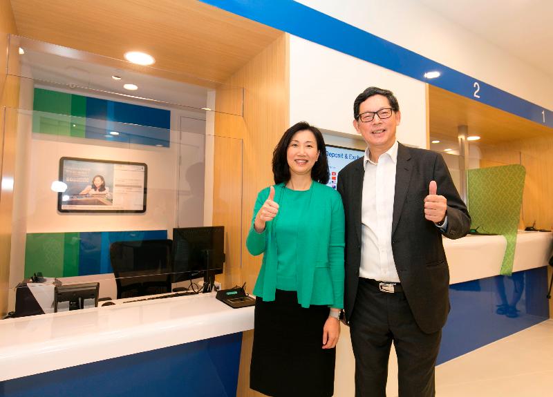 The Chief Executive Officer of Standard Chartered Bank (Hong Kong), Ms Mary Huen (left), and the Chief Executive of the Hong Kong Monetary Authority, Mr Norman Chan, are pictured next to lower-height bank counters for convenient use by people who are physically challenged in Tin Shui Wai today (August 17).
