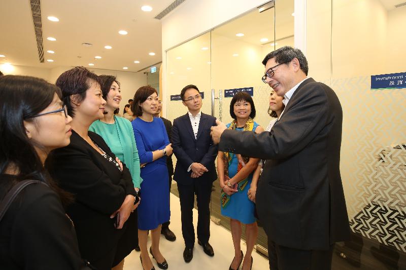 香港金融管理局總裁陳德霖（右一）今日（八月十七日）在天水圍向渣打銀行（香港）行政總裁禤惠儀（左三）及銀行代表了解分行的營運情況。