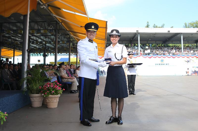 The Commissioner of Correctional Services, Mr Yau Chi-chiu (left), presents a Best Recruit Award, the Golden Whistle, to Assistant Officer II Miss Wong Sin-yee at the Passing-out cum Commissioner's Farewell Parade of the Correctional Services Department at its Staff Training Institute in Stanley today (August 18).