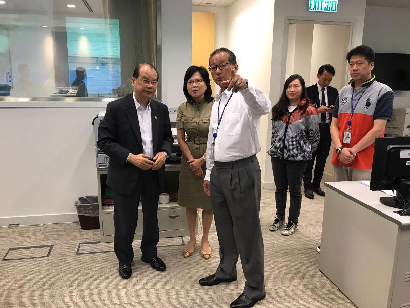 The Acting Chief Executive, Mr Matthew Cheung Kin-chung, visited the Emergency Monitoring and Support Centre of the Security Bureau to be briefed about the measures that were put in place in response to Typhoon Hato's threat at the time when Hurricane Signal No. 10 was hoisted today (August 23). Photo shows the Permanent Secretary for Security, Mrs Marion Lai (second left) briefing Mr Cheung (first left) the operation of the Centre. 