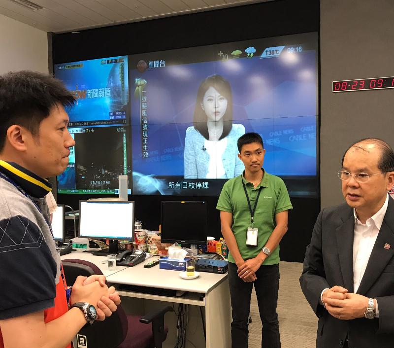 The Acting Chief Executive, Mr Matthew Cheung Kin-chung (right), visits the Emergency Monitoring and Support Centre of the Security Bureau to be briefed about the measures that were put in place in response to Typhoon Hato's threat at the time when Hurricane Signal No. 10 was hoisted today (August 23). 