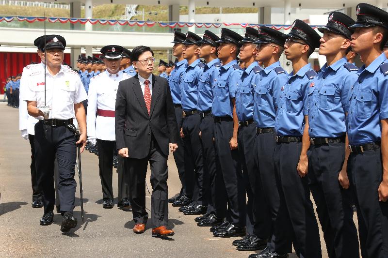 The Secretary for Security, Mr John Lee (second left), reviews the 179th Fire Services passing-out parade at the Fire and Ambulance Services Academy in Tseung Kwan O today (August 24).