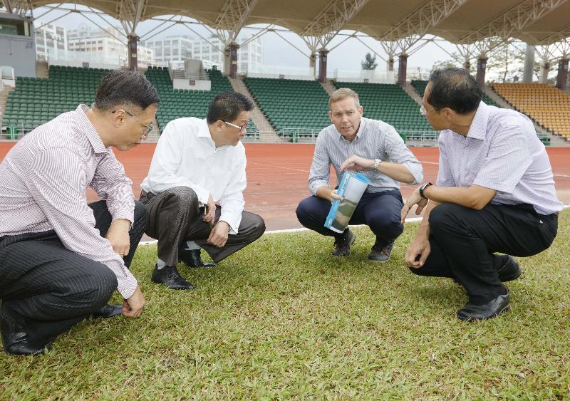 The Under Secretary for Home Affairs, Mr Jack Chan (second left), and the Acting Director of Leisure and Cultural Services, Mr Raymond Fan (first left), were briefed by Leisure and Cultural Services Department’s Head of the Sports Turf Management Section, Mr Cameron Hodgkins (second right), about the impact of sea water on the turf pitch of the Siu Sai Wan Sports Ground.