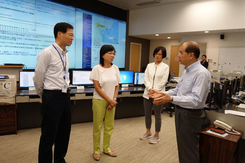 The Acting Chief Executive, Mr Matthew Cheung Kin-chung (first right), visited the Emergency Monitoring and Support Centre of the Security Bureau again at around 11.30am today (August 27). Photo shows Mr Cheung being briefed by the Permanent Secretary for Security, Mrs Marion Lai (second left), and the Under Secretary for Security, Mr Sonny Au, (first left) on the latest situation of the works in response to Typhoon Pakhar.