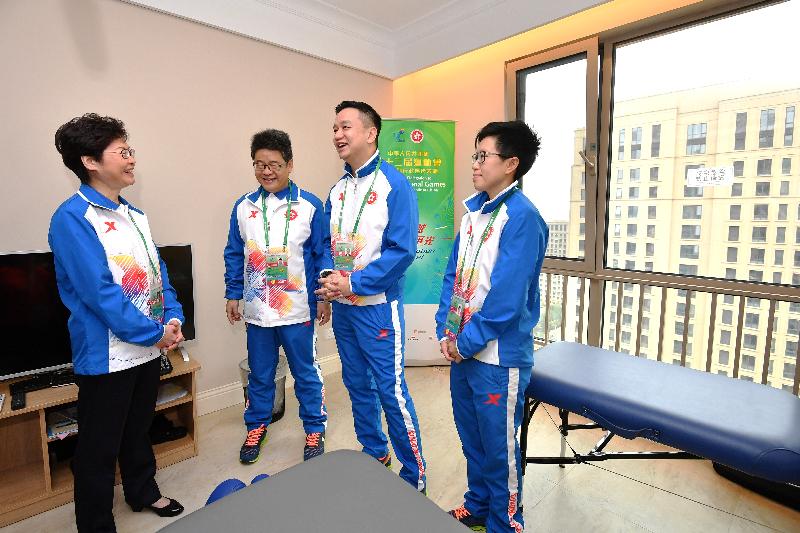 The Chief Executive, Mrs Carrie Lam, visited the Hong Kong athletes at the Athletes' Village today (August 27) before attending the opening ceremony of the 13th National Games in Tianjin. Photo shows Mrs Lam (first left) chatting with the medical and supporting team in the village's medical room.