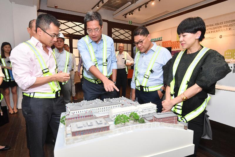 The Secretary for Development, Mr Michael Wong (second left), visited Central and Western District today (August 29) to inspect the progress of works for the revitalisation of the Central Police Station Compound. Picture shows Mr Wong viewing a model of the Compound and being briefed by the Executive Director of Charities and Community of the Hong Kong Jockey Club, Mr Cheung Leong (first left), on the revitalisation project and its development. Looking on are the Chairman of the Central and Western District Council, Mr Yip Wing-shing (second right), and the District Officer (Central and Western), Mrs Susanne Wong (first right). 
