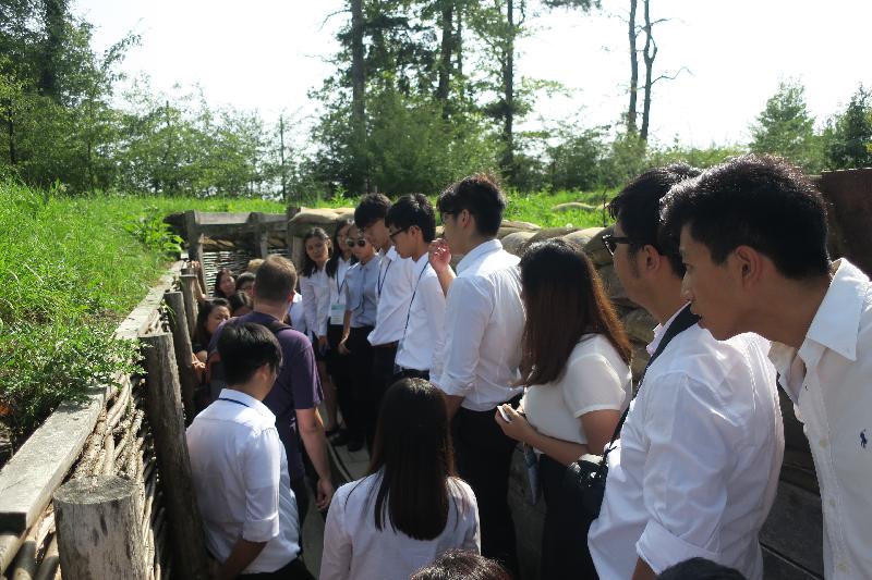 A group of young Hong Kong people taking part in the "Walk the Hong Kong Spirit" programme in Belgium on August 29 is pictured in a trench during a guided tour of the Memorial Museum Passchendaele 1917 dedicated to World War I in Zonnebeke, Flanders. 