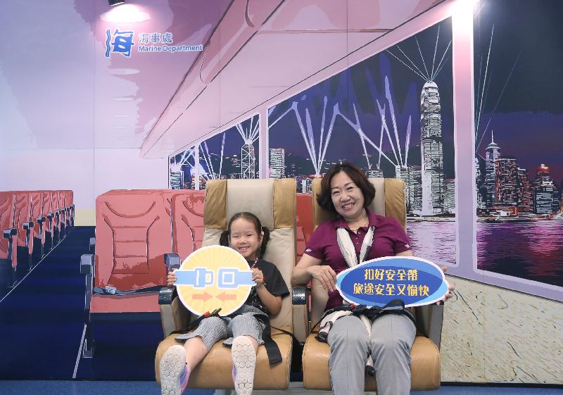 The Marine Department today (September 5) set up a large backdrop of Hong Kong scenery decorated with genuine cabin seats at the waiting lounge of the Hong Kong-Macau Ferry Terminal in Sheung Wan. Photo shows passengers trying the seats with their seat belts fastened.