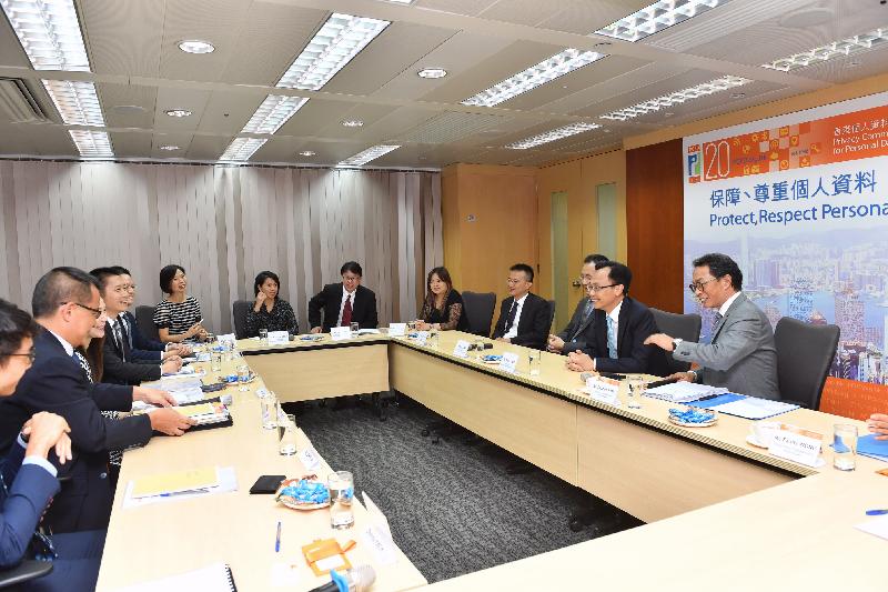 The Secretary for Constitutional and Mainland Affairs, Mr Patrick Nip, visits the Office of the Privacy Commissioner for Personal Data (PCPD) today (September 5). Picture shows Mr Nip (second right) being briefed by the Privacy Commissioner for Personal Data, Mr Stephen Wong (first right), and other colleagues on the latest work of PCPD.