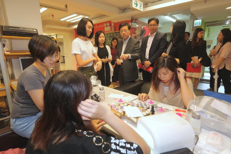 During his visit to Kowloon City this afternoon (September 7), the Secretary for Security, Mr John Lee (back row, centre), visits the Kowloon City District Youth Outreaching Social Service Centre of Yang Memorial Methodist Social Service, where he is briefed on the Centre's services and facilities.