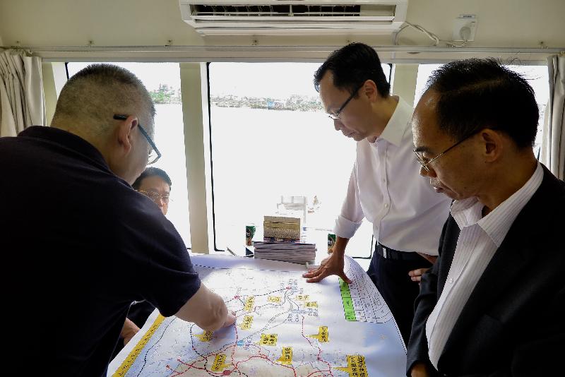 The Secretary for Constitutional and Mainland Affairs, Mr Patrick Nip (second right), is briefed by an official of the Zhongshan Transportation Bureau and a shipping company representative on the transportation network connecting Zhongshan and other cities in the Guangdong-Hong Kong-Macao Bay Area while on board a ferry from Zhongshan to Shenzhen today (September 8).