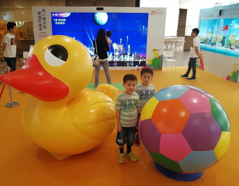 The last leg of the "Hong Kong Special Administrative Region 20th Anniversary Roving Exhibition" opened at Times Square in Causeway Bay today (September 8). Photo shows children posing for photos next to the giant rubber duck and football at the venue.