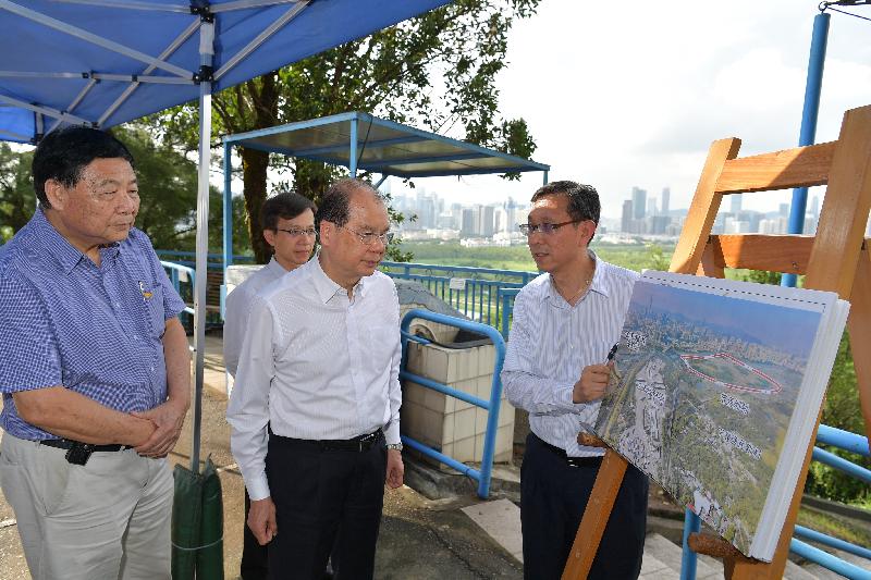 The Chief Secretary for Administration, Mr Matthew Cheung Kin-chung (second left), is briefed by the Project Manager (New Territories West) of Civil Engineering and Development Department, Mr Ambrose Cheong (first right), on the development of the Lok Ma Chau Loop this afternoon (September 8). Looking on was the Chairman of the North District Council, Mr So Sai-chi (first left).