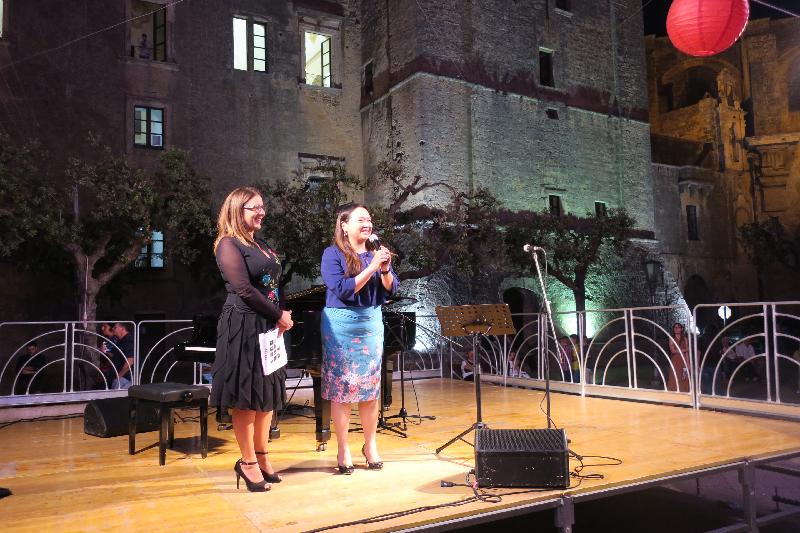 The Deputy Representative of the Hong Kong Economic and Trade Office in Brussels, Miss Alice Choi (right), addresses a crowd of about 600 people gathered in the main square in Tricase, Italy, before an open-air Hong Kong Party on September 7 (Tricase time).